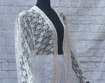 Sheer loosefitting white lace lightweight kimono cardigan duster jacket. Dropped shoulders, buttonless placket,long sleeves. Unlined. Breezy
