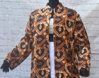 Unisex. Easy African mudcloth ,Ankara wax print loosefitting ,unlined, open front, knee length jacket cover-up.Stand collar.Long sleeves.