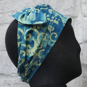 100% cotton headband and belt with batik scroll artwork.  Turquoise hues.Reversible, adjustable, double-sided. Getaway. Machine washable.