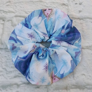 Fairytale snow princess scrunchie ponytail and bun holder. Soft ,easy wear and care cotton with interior elastic band. Machine washable.