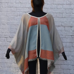 Taupe colorblock large geometric squares. Ruana style easy sleeveless jacket,vest,cover-up.Hook,eye closure.Fringed sides and hem. Washable.