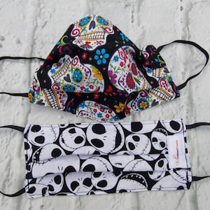 Adult pleated,adjustable face mask. Double layer pre-washed, pre-shrunk cotton.Elastic bands. Skulls,skulls,skulls. Reversible, washable.