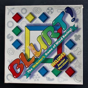 May include: A square board game box for Blurt! The Webster's Game of Word Racing! featuring a colorful title in bubble letters, a central square frame, and various small gray icons like a plane, button, and snowflake on a white background.