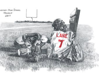 May include: A black and white pencil drawing of a football player's equipment on a grassy field. The equipment includes a helmet, shoulder pads, a football, and a jersey with the name "LANE" and the number "7" on it. The drawing is titled "Frankfort High School Trojans 2017".