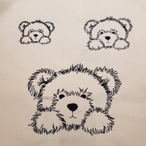 May include: A black and white line drawing of three fluffy teddy bears. The bears are drawn in a simple, cartoon style. The bears are all looking to the right.