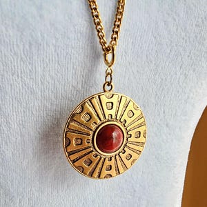 Vintage Sarah Coventry Medallion Necklace, Long Gold Tone Pendant Necklace Greek Key Aztec with Red Stone Chunky Statement Jewelry, 70s 80s