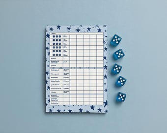 May include: A rectangular score sheet with a light blue background and dark blue star pattern, featuring a grid for game scoring. Five translucent blue six-sided dice with white pips are arranged in a vertical column to the right of the sheet.