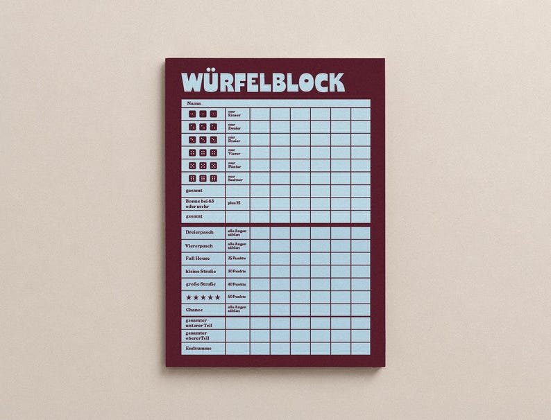 May include: A rectangular score sheet for a dice game with a dark maroon border and a light blue grid. The header reads W&Uuml;RFELBLOCK in large letters. The sheet features columns for player names and rows for dice combinations and point totals.