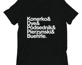 May include: Black t-shirt with white text that reads "Konerko & Dye & Podsednik & Pierzynski & Buehrle."