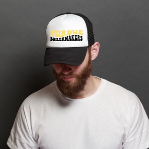 Caucasian male wearing a black and white Purdue Boilermakers trucker hat showcasing the SVG design available for instant download.