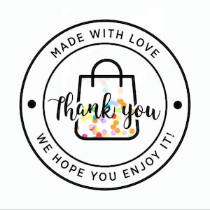 May include: Black and white circular sticker with the text "Made with Love" and "We Hope You Enjoy It!" around a shopping bag with confetti inside. The text "Thank you" is written in a cursive font inside the sticker.