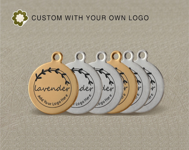 May include: Six round metal tags with a floral design and the word "lavender" in a script font. The tags are in two finishes: gold and silver. The text "Add Your Logo Here" is printed on the gold tag.