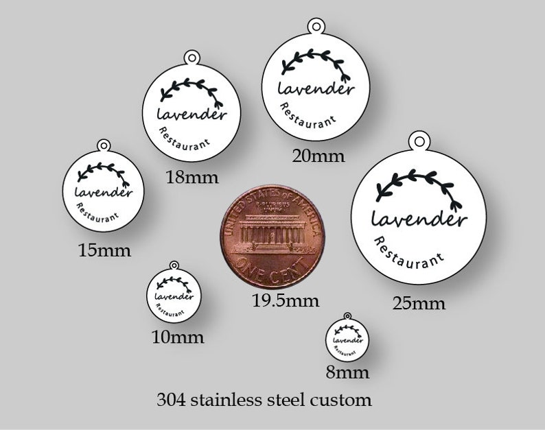May include: A set of six round, white metal tags with a black floral design and the text "Lavender Restaurant". The tags are shown with a penny for size comparison. The tags are available in sizes 8mm, 10mm, 15mm, 18mm, 20mm, and 25mm.