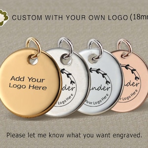 May include: Three round metal charms with a 18mm diameter. The charms are gold, silver, and rose gold. Each charm has a small loop at the top for attaching to a necklace or bracelet. The gold charm says "Add Your Logo Here". The silver and rose gold charms have a simple design with a leaf motif and the text "under your logo here".