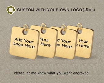 May include: Four gold-colored, square tags with rounded corners, each with a small hole and a gold ring. The tags have the text "Add Your Logo Here" and "Your Here" printed on them. The text "CUSTOM WITH YOUR OWN LOGO (15mm)" is at the top.