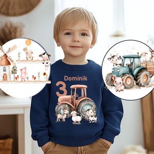 Peut inclure: Un sweat-shirt bleu marine pour enfant avec un motif de tracteur, le nom "Dominik" et le chiffre "3". Le motif comprend des illustrations d'animaux de la ferme. Le sweat-shirt est bleu marine.