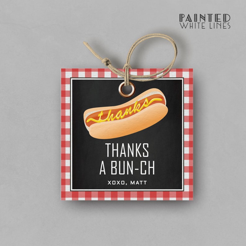 May include: Red and white checkered gift tag with a black chalkboard background. The chalkboard has a cartoon hot dog with mustard and the text "Thanks a bun-ch xoxo, Matt".