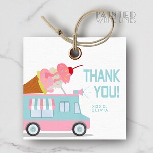 May include: A pink and blue ice cream truck with a large ice cream cone on top. The truck has a white awning and a speaker. The text "THANK YOU! XOXO, OLIVIA" is printed on the tag.