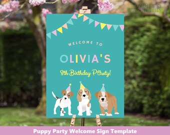 May include: A teal sign with the text "WELCOME TO OLIVIA'S 8th Birthday Party!" and illustrations of three puppies wearing party hats. The sign has a banner of colorful flags at the top and is displayed on a wooden easel.
