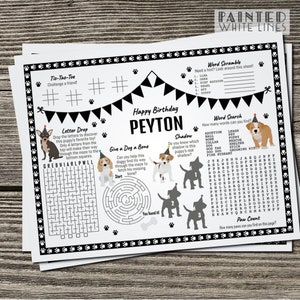 K&ouml;nnte beinhalten: Ein schwarz-wei&szlig;es, druckbares Aktivit&auml;tsblatt f&uuml;r eine Geburtstagsparty mit Hundethema. Das Blatt enth&auml;lt ein Suchwort, ein Wort-Scramble, Tic-Tac-Toe, einen Buchstaben-Drop, Schatten-Matching und ein Labyrinth. Das Blatt ist mit Pfotenabdr&uuml;cken und einem Geburtstagsbanner verziert. Der Name Peyton steht oben auf dem Blatt.