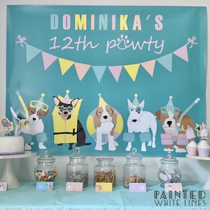 May include: A turquoise banner with the text "Dominika's 12th pawty" and a string of pink, yellow, and blue flags. Five dogs wearing party hats and goggles are depicted on the banner. A table with jars of candy and snacks is set up in front of the banner. The text "Painted White Lines" is visible in the bottom right corner.