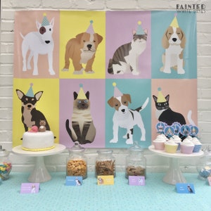 May include: A birthday party table setting with a cake decorated with a dog and cat figurine, cupcakes with animal toppers, and jars of snacks. A colorful backdrop features illustrations of dogs and cats wearing party hats. The backdrop has the text "Painted White Lines".