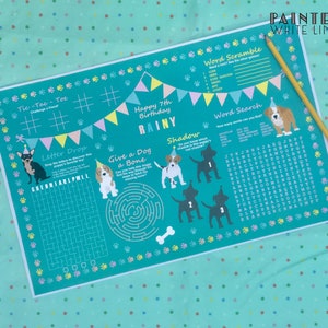 May include: A teal blue printable party game for a 7th birthday with a dog theme. The game includes a word search, word scramble, tic-tac-toe, letter drop, and a maze. The game is decorated with paw prints, dog bones, and party flags.
