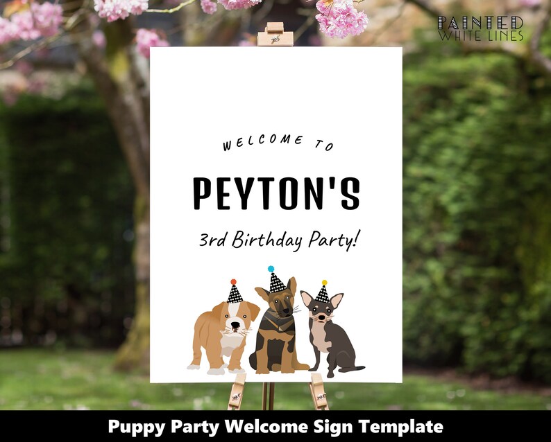 May include: A welcome sign for a puppy-themed birthday party. The sign is white with black text that reads "Welcome to Peyton's 3rd Birthday Party!" There are three cartoon puppies wearing party hats.