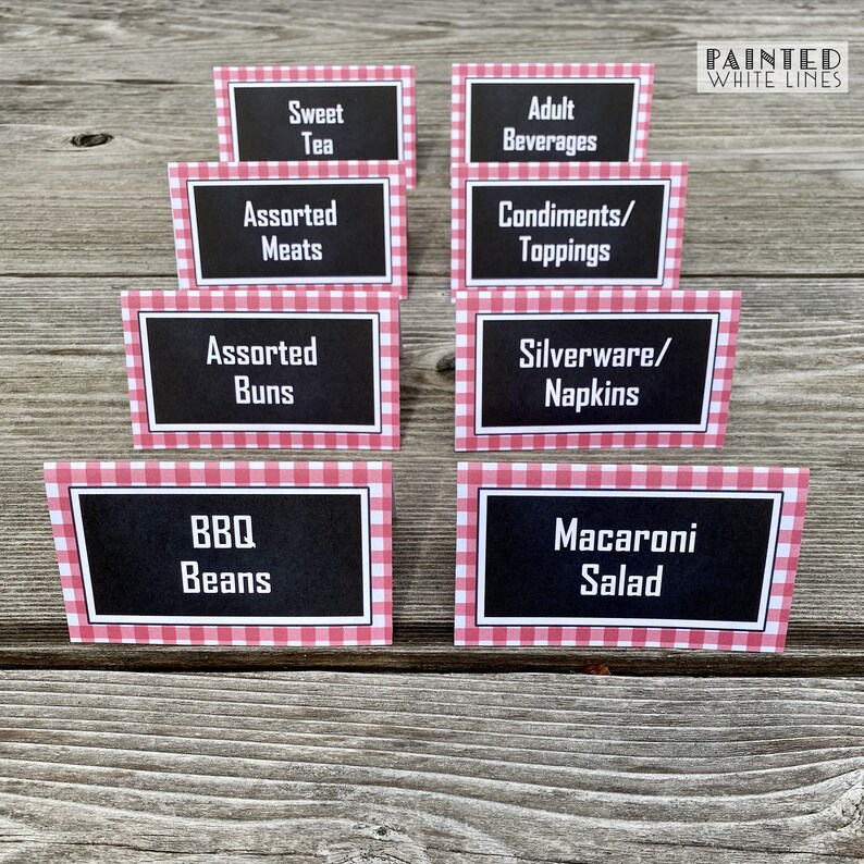May include: Eight red and white gingham table cards with black text. The cards list various food and beverage options for a party or event. The text on the cards reads: Sweet Tea, Assorted Meats, Assorted Buns, BBQ Beans, Adult Beverages, Condiments/Toppings, Silverware/Napkins, Macaroni Salad.