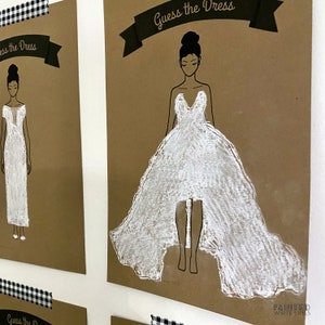 May include: A set of brown paper cards with the text "Guess the Dress" printed on them. Each card features a line drawing of a woman in a white dress. The dresses are drawn with white chalk.