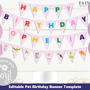 May include: Pink and white triangle banner with the words "Happy Birthday Ophelia" in colorful letters. The banner has small animal illustrations on each triangle. The banner is on a white wood background with pink balloons.