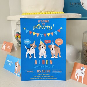 May include: A blue and yellow birthday party invitation with a paw print design. The invitation says "It's time to pawty!" and features three cartoon dogs wearing party hats. The text on the invitation says "Aiden is turning 5" and includes the date and time of the party. The invitation also includes the address of the party and the RSVP information.