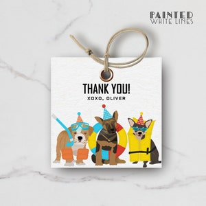 May include: Thank you card with a white background and three dogs wearing party hats. The dogs are wearing swimming gear, including goggles, a life vest, and a life preserver. The text on the card reads "Thank You! xoxo, Oliver".
