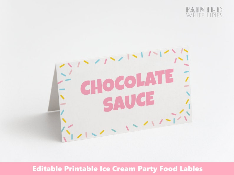 May include: Printable food label with a pink and white background. The label has a pink border with colorful sprinkles. The text "CHOCOLATE SAUCE" is in pink letters.