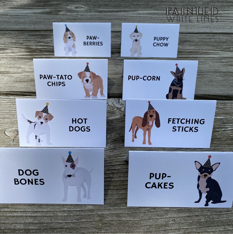 May include: A set of ten white cards with illustrations of dogs wearing party hats and text describing different dog-themed treats. The text includes "Paw-Tato Chips", "Pup-Corn", "Hot Dogs", "Fetching Sticks", "Dog Bones", "Pup-Cakes", "Paw-Berries", "Puppy Chow".