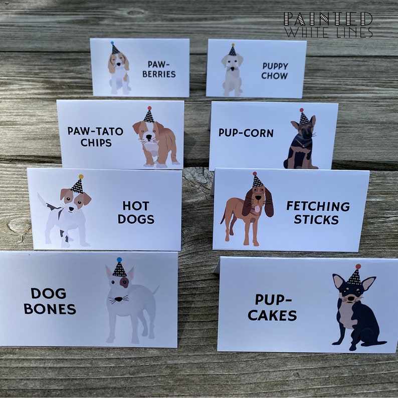 May include: A set of ten white cards with illustrations of dogs wearing party hats and text describing different dog-themed treats. The text includes "Paw-Tato Chips", "Pup-Corn", "Hot Dogs", "Fetching Sticks", "Dog Bones", "Pup-Cakes", "Paw-Berries", "Puppy Chow".