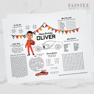 May include: A printable birthday activity sheet for a child named Oliver, featuring a red race car with the number 5 on it. The sheet includes a word search, word scramble, maze, and tic-tac-toe game. The sheet is decorated with red, orange, and yellow flags.