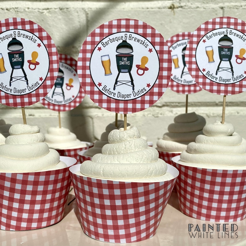 May include: Red and white checkered cupcake liners with white frosting and a round, red and white checkered cupcake topper that says "Barbeque & Brewskis" with a grill, beer, and pacifier graphic. The text "The Smiths" is on the grill. The text "Before Diaper Duties" is below the graphic.