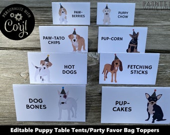May include: White table tents with illustrations of dogs wearing party hats and food-themed text. The text includes "Paw-Berries", "Puppy Chow", "Paw-Tato Chips", "Pup-Corn", "Hot Dogs", "Fetching Sticks", "Dog Bones", and "Pup-Cakes".