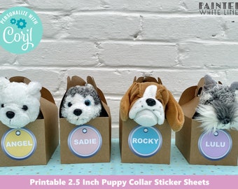 May include: Four brown boxes with white lines, each containing a stuffed animal puppy. The boxes have colorful round stickers with the names "Angel", "Sadie", "Rocky", and "Lulu" on them. The text "Printable 2.5 Inch Puppy Collar Sticker Sheets" is at the bottom of the image.