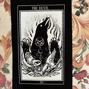May include: Black and white tarot card patch featuring the Devil card image. The card depicts a crow with a pentagram on its chest, surrounded by two chained figures. The card number XV is at the bottom.