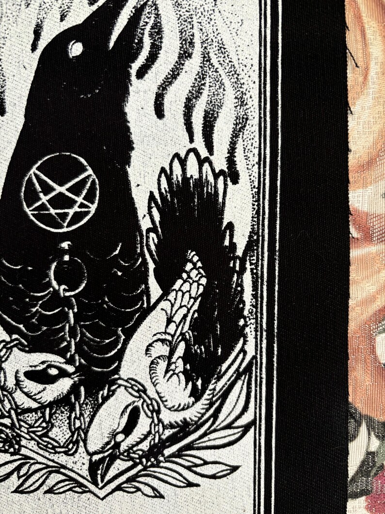 May include: Black and white illustration of a crow with a pentagram on its chest, chained to a bird with its wings spread. The image is on a white background with a black border.