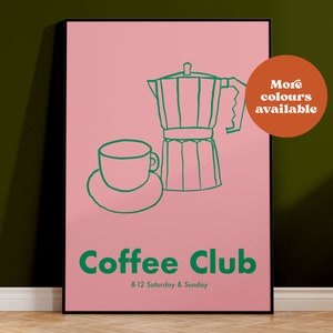 May include: A framed pink poster featuring a green line drawing of a coffee maker and a cup and saucer. The words "Coffee Club" are printed in green, along with the opening hours. A brown circle with the text "More colours available" is in the upper right.
