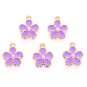 May include: Five gold-coloured flower charms with a purple enamel finish. Each charm has a small loop at the top for attaching to jewellery or other crafts.