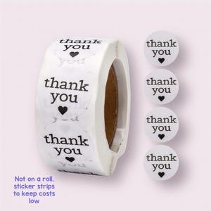 May include: Roll of white round stickers with black text that says "thank you" and a small black heart. The stickers are not on a roll, but in strips to keep costs low.