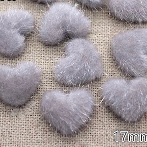 May include: A group of 10 gray fuzzy heart-shaped embellishments, each measuring 17 mm in diameter.
