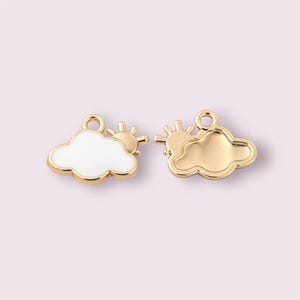 May include: Two cloud and sun charms. One charm is white with a gold outline and a gold sun. The other charm is gold. Both charms have a loop at the top for attaching to jewellery or other crafts.