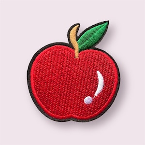 May include: Embroidered apple patch with a bright red body and a black border. The design includes a green leaf, a yellow stem, and white and purple accents, creating a detailed fruit illustration. Ideal for adding to clothing or accessories.