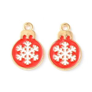 May include: Two gold-tone Christmas ornament charms with red enamel and a white snowflake design.