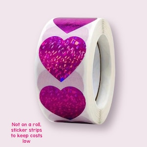 May include: Roll of pink holographic heart stickers. Not on a roll, sticker strips to keep costs low.